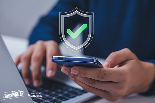 Micro Deposit Verification A Man Working On a Laptop Holding a Smartphone Showing, Micro Deposit Verification