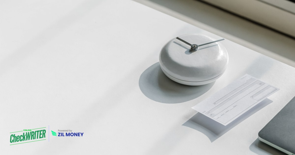 Same day check printing on blank check stock Desk clock beside a freshly printed business check representing same day check printing